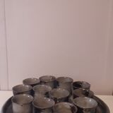 Ceramic liquor service with a decanter and 12 small glasses on tray