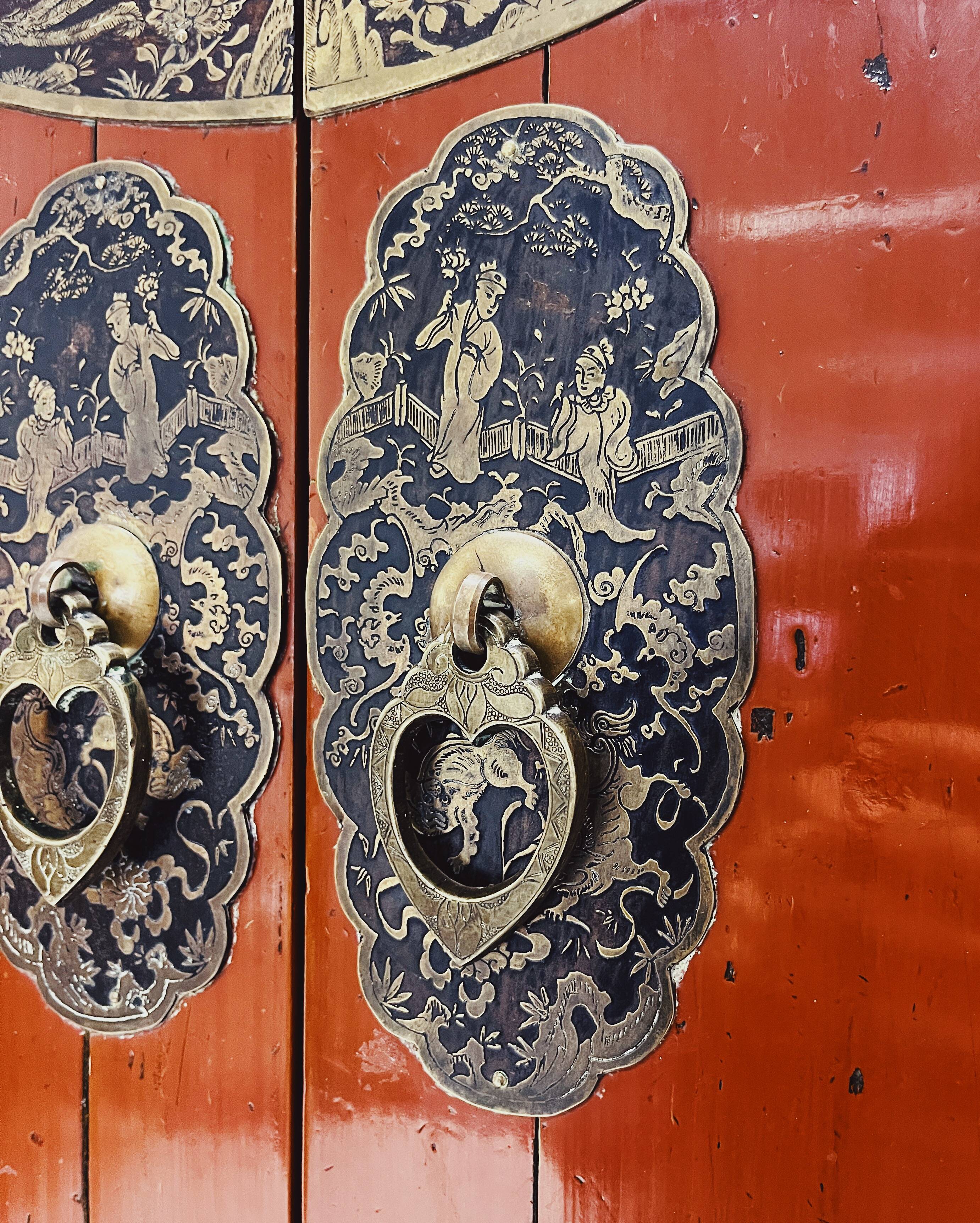 Antique red cabinet with brass details