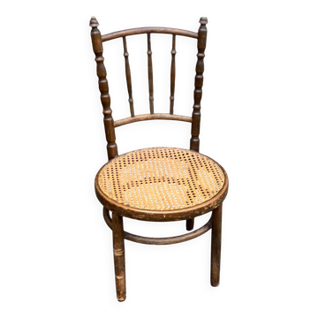 Vintage 19th-century bistro chair made of curved solid wood and caned in the Thonet style.