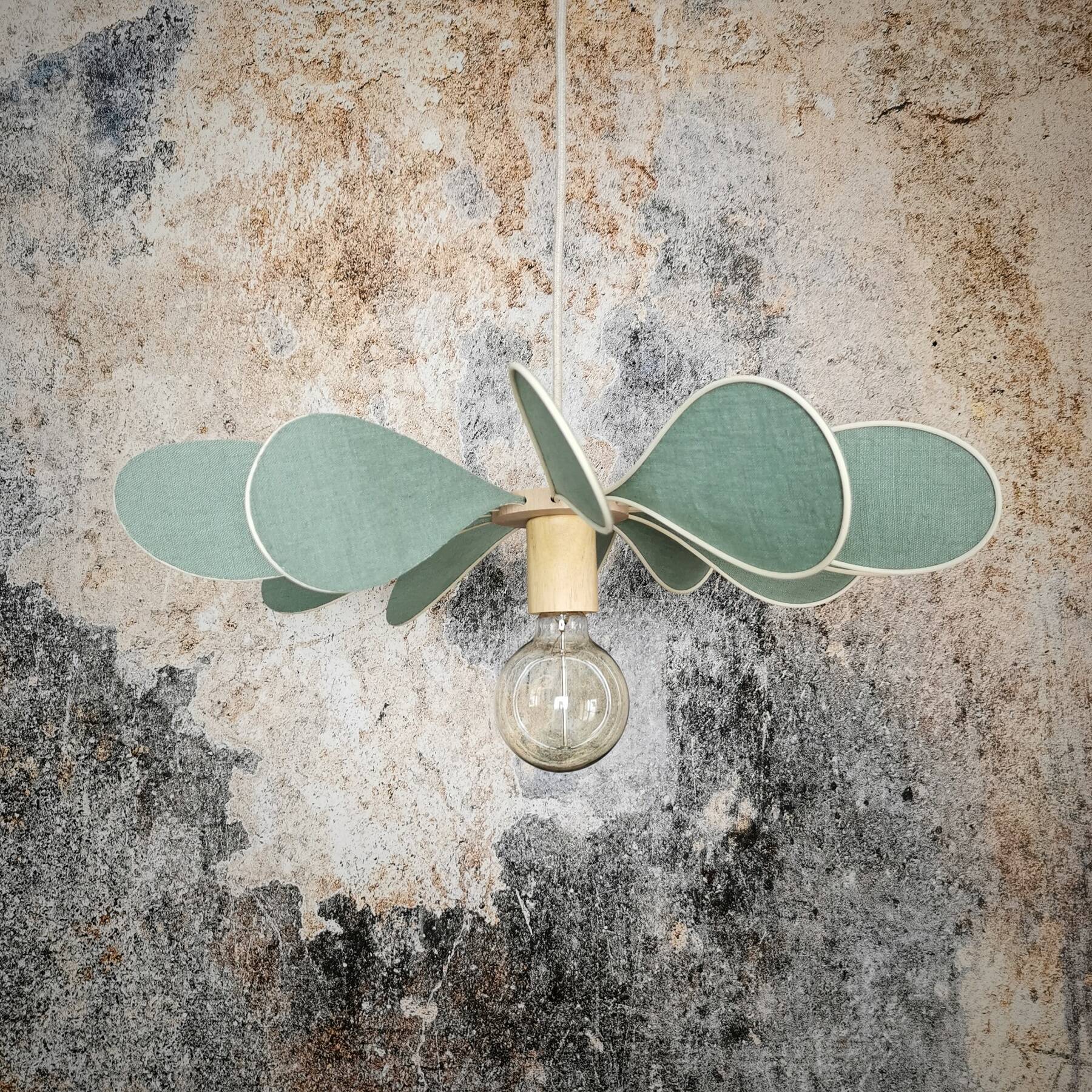12-blade propeller suspension in rattan and celadon green linen