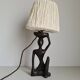Ebony lamp with seated woman / 1930s