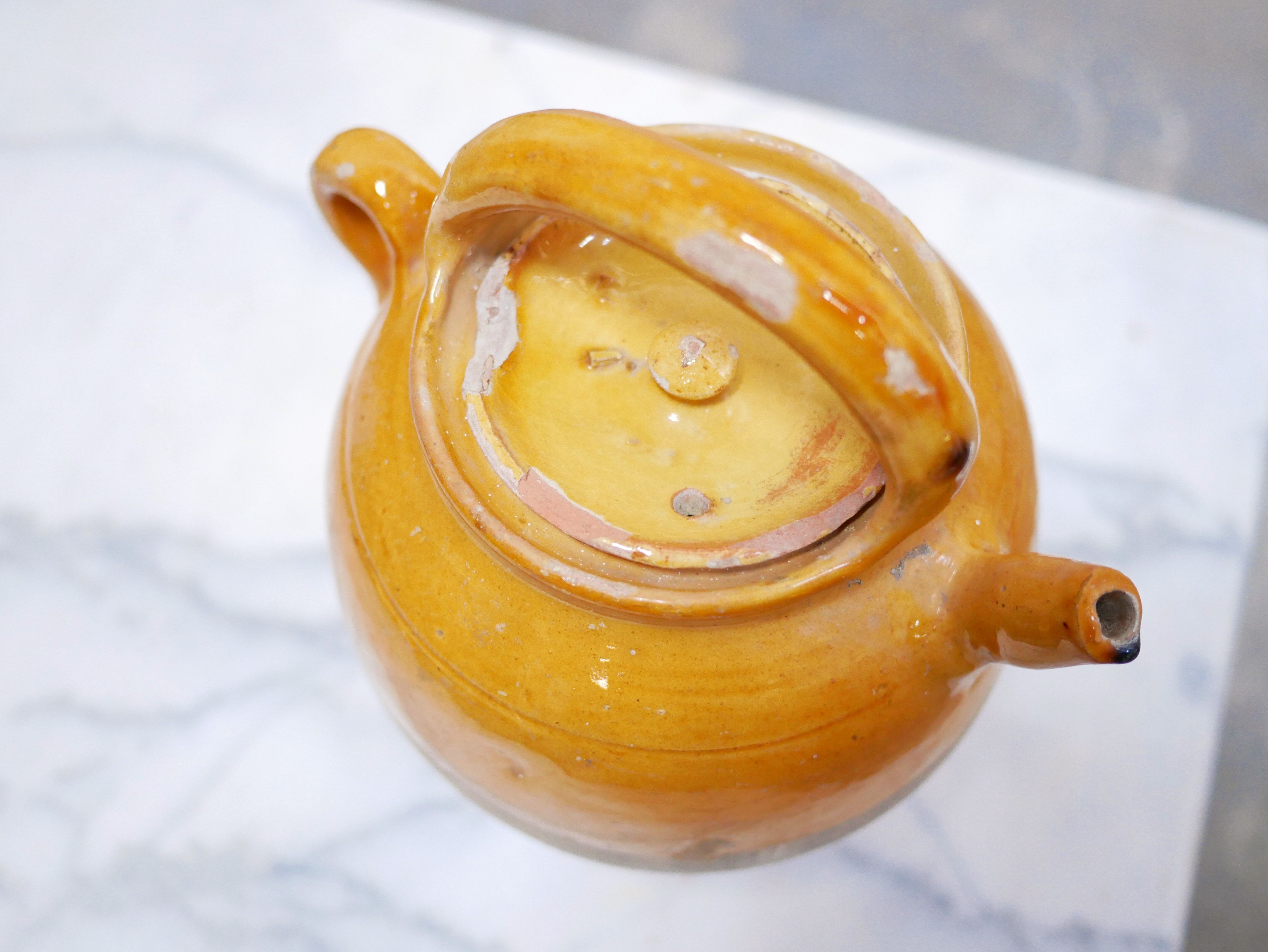 Old gargoulette pot in glazed terracotta