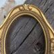 Stylized oval gold frame