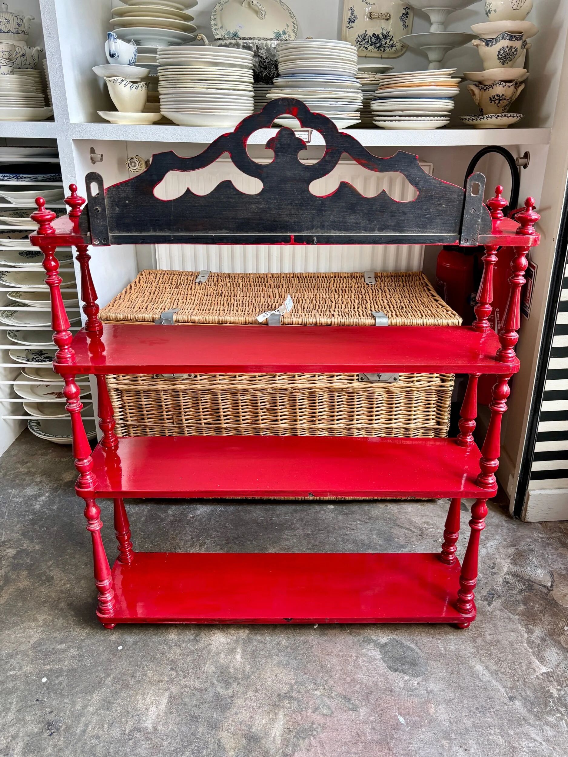 Wall shelf with 4 red lacquered wooden shelves.