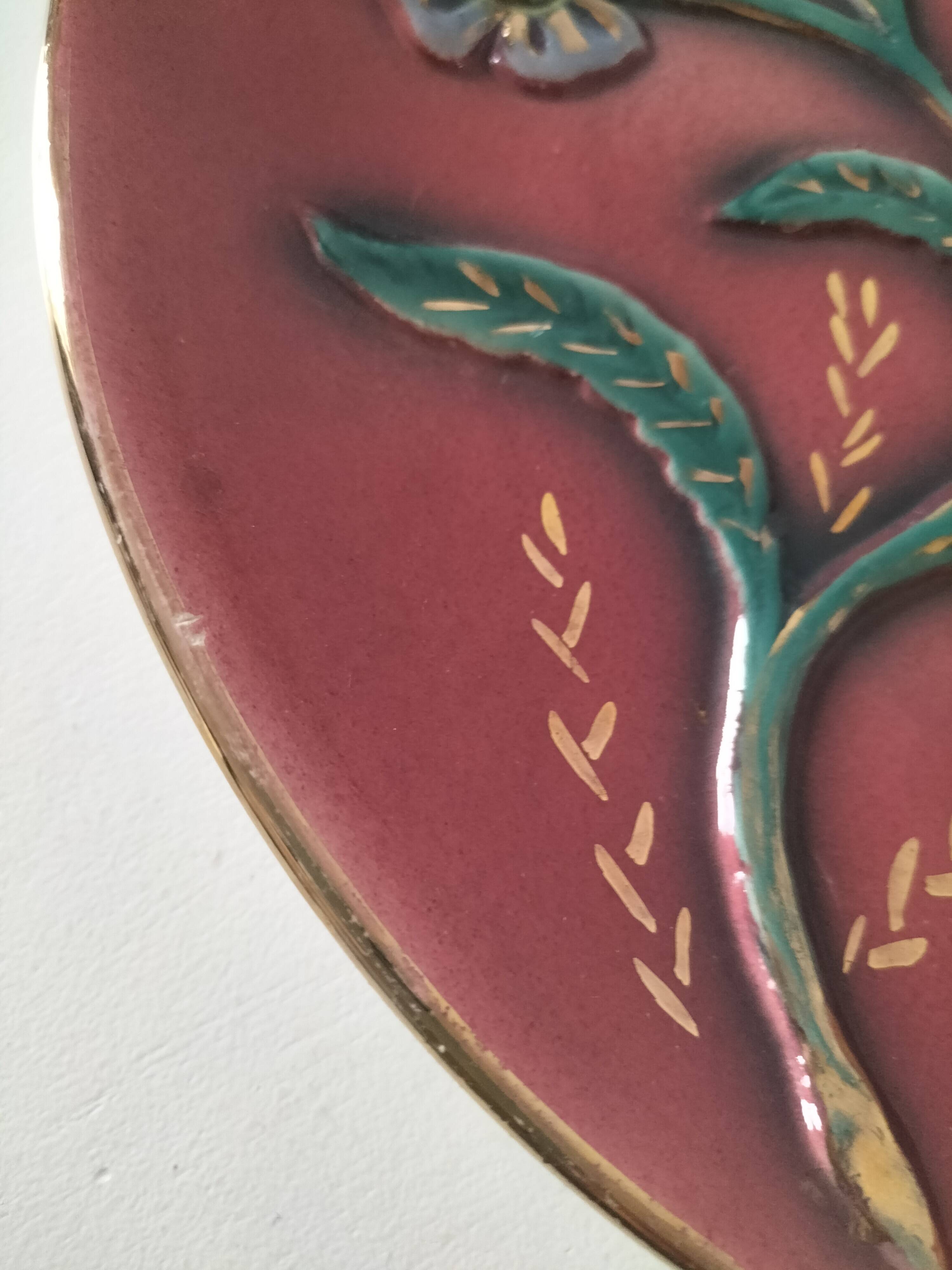 Large antique plate in floral slip with hand-painted relief decoration