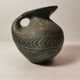 Vintage native american jug pot with geometric patterns in green / gray tones
