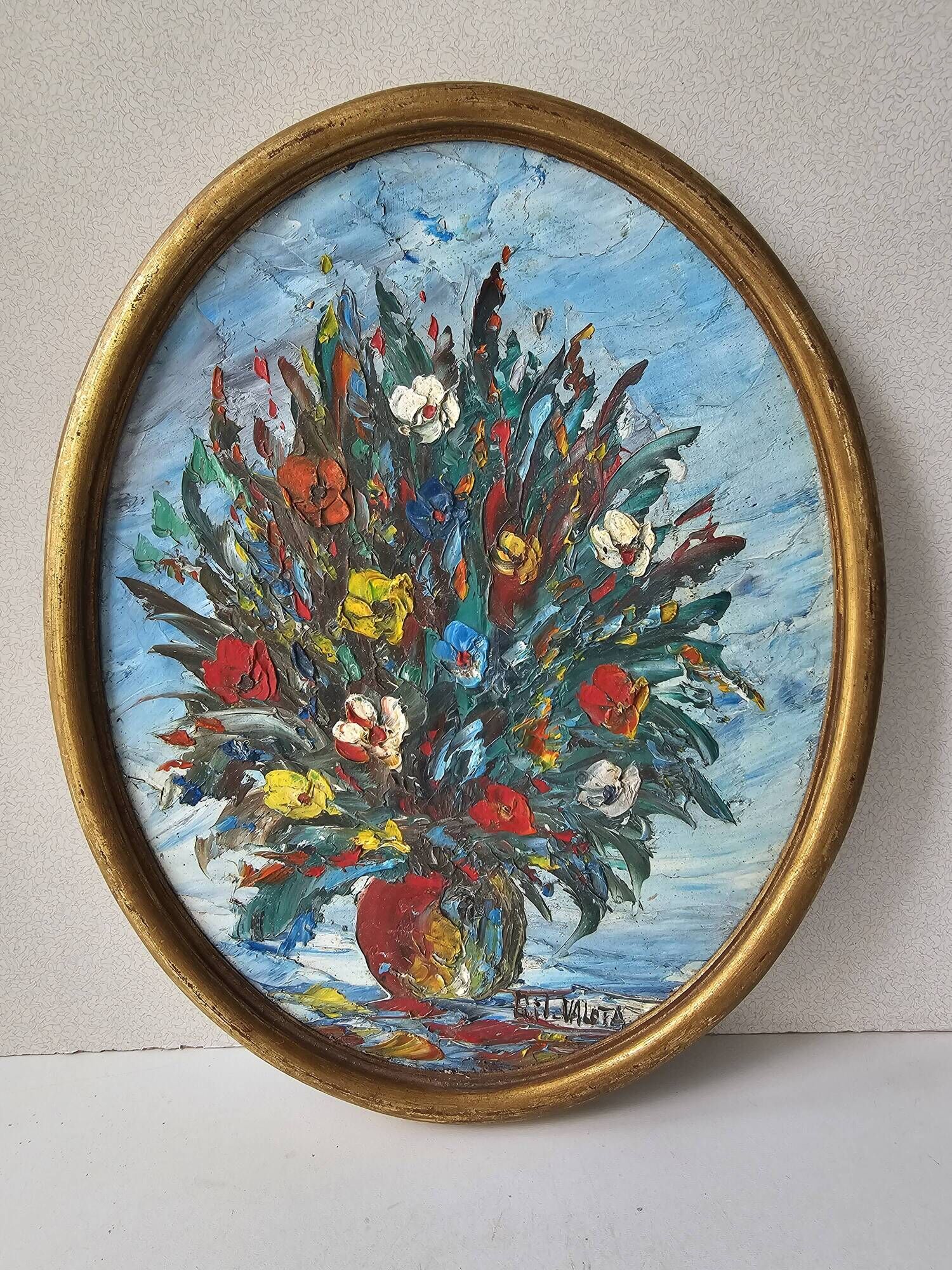 Oil painting on panel of a bouquet of colourful flowers in a vase, signed Valota.