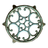 Antique round turquoise cast iron trivet.