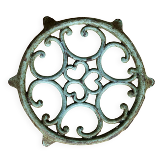 Antique round turquoise cast iron trivet.