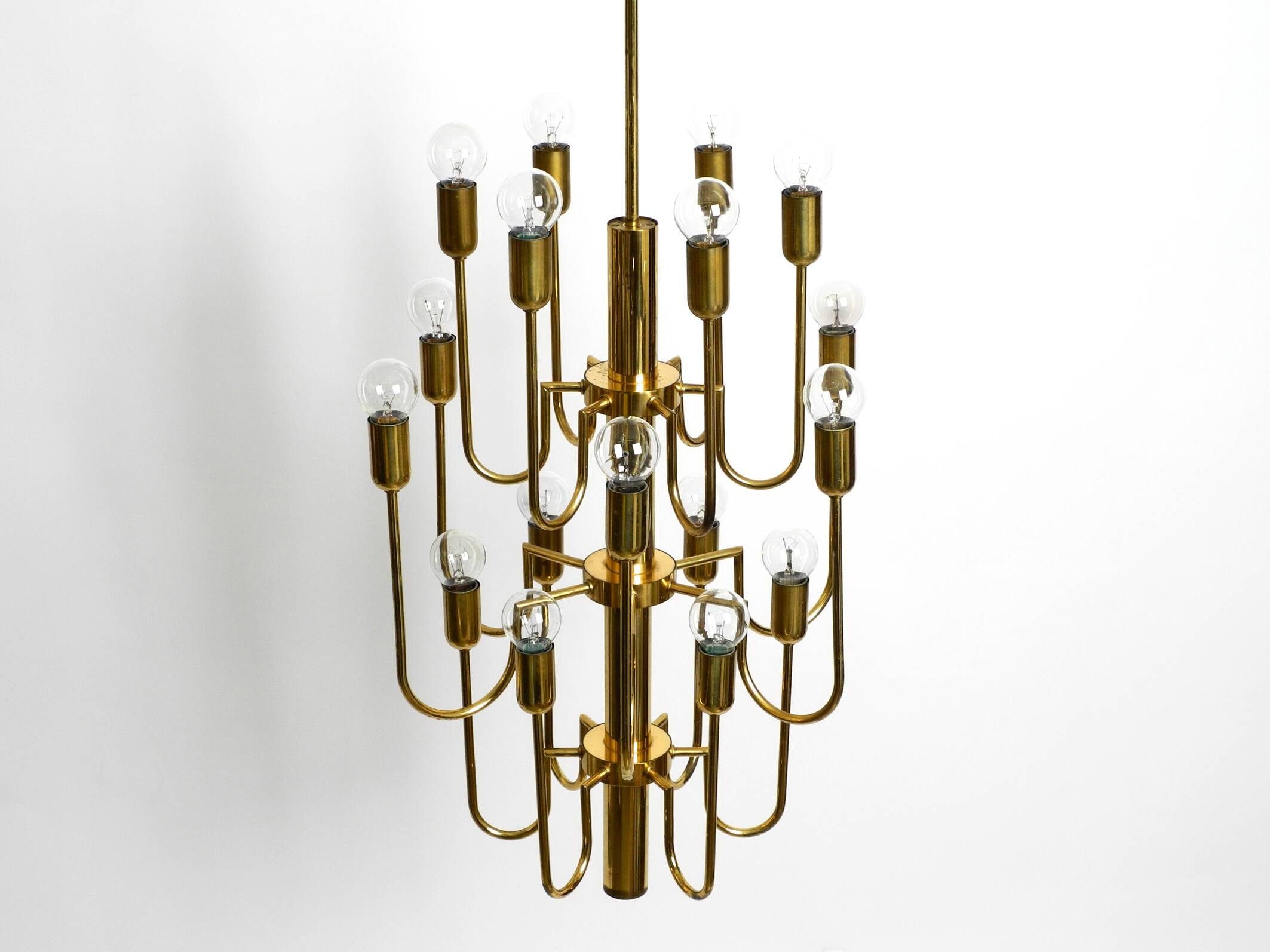 Three staged 18 arm Mid Century brass chandelier with a long brass rod