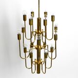Three staged 18 arm Mid Century brass chandelier with a long brass rod