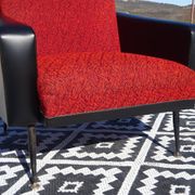 Pair of vintage armchairs in black faux leather and red fabric.