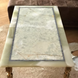 Coffee table in onyx and brass