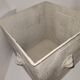 Square planter with a patinated iron lion's head