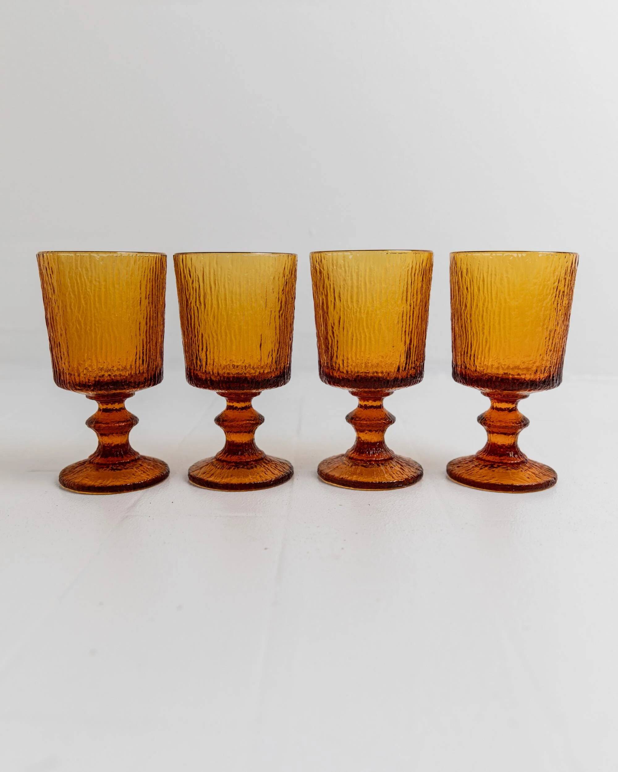 Lot of 4 vintage wine glasses from the 1970s, textured amber on a stem, design by Timo Sarpaneva for Iittala.