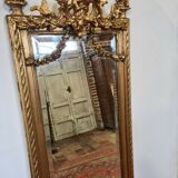 Mirror with an angel in gilded wood and stucco 166x61cm