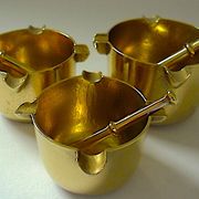 Three "vintage" bronze ashtrays with golden natural patina forming mortars with their drumsticks