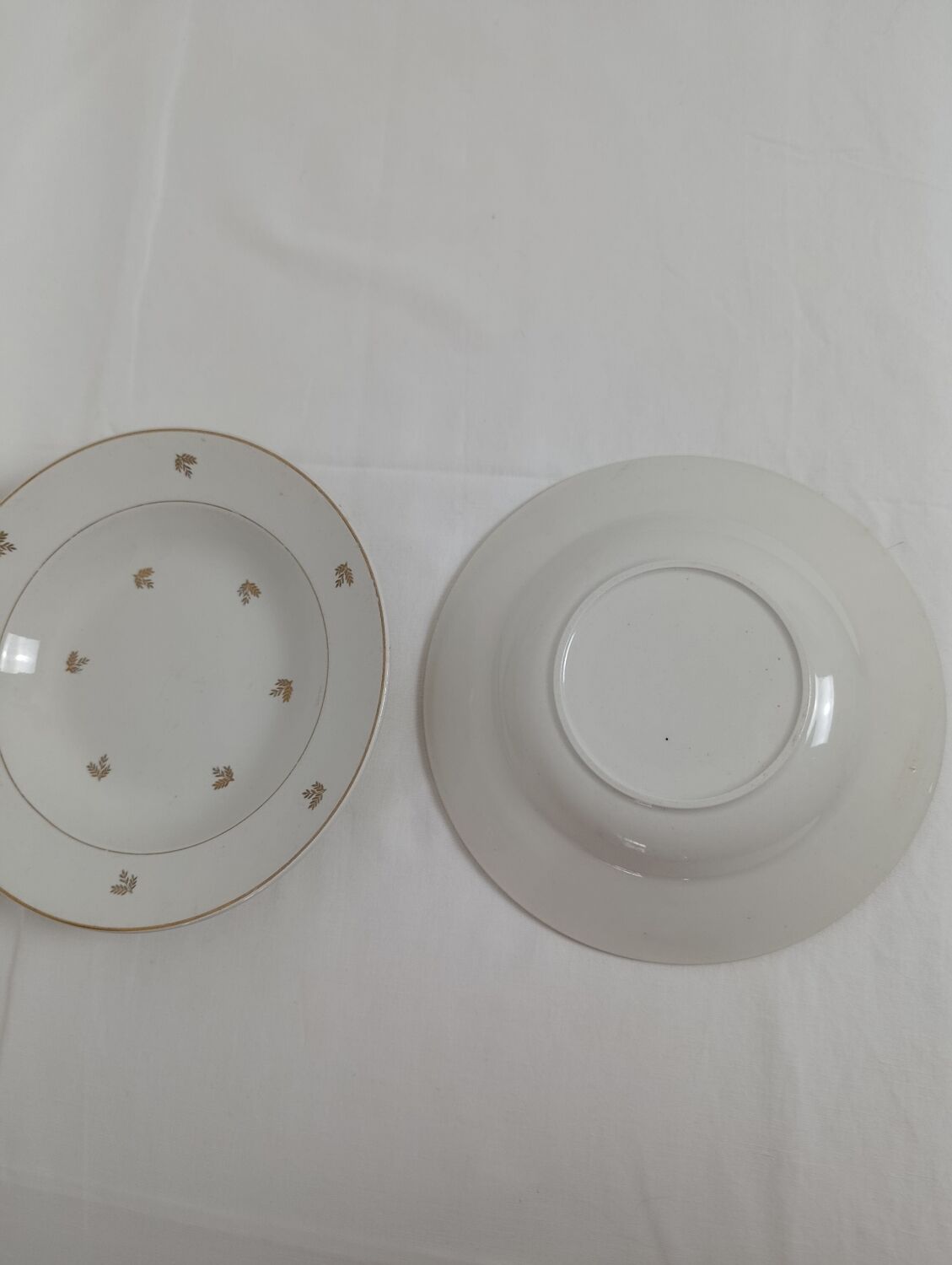 Set of 2 white deep plates with a gold pattern.