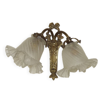 Double wall light in bronze in French Rococo style with white glass shades featuring patterns.