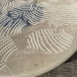 Round ethnic handmade fish dish