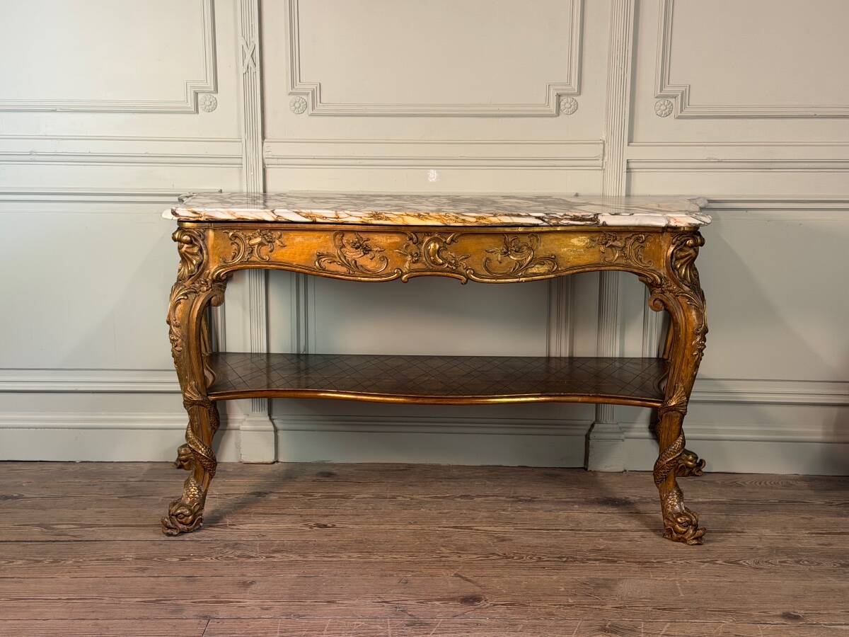 Golden wooden console, four legs adorned with sea monsters, purple breccia marble, around 1900.