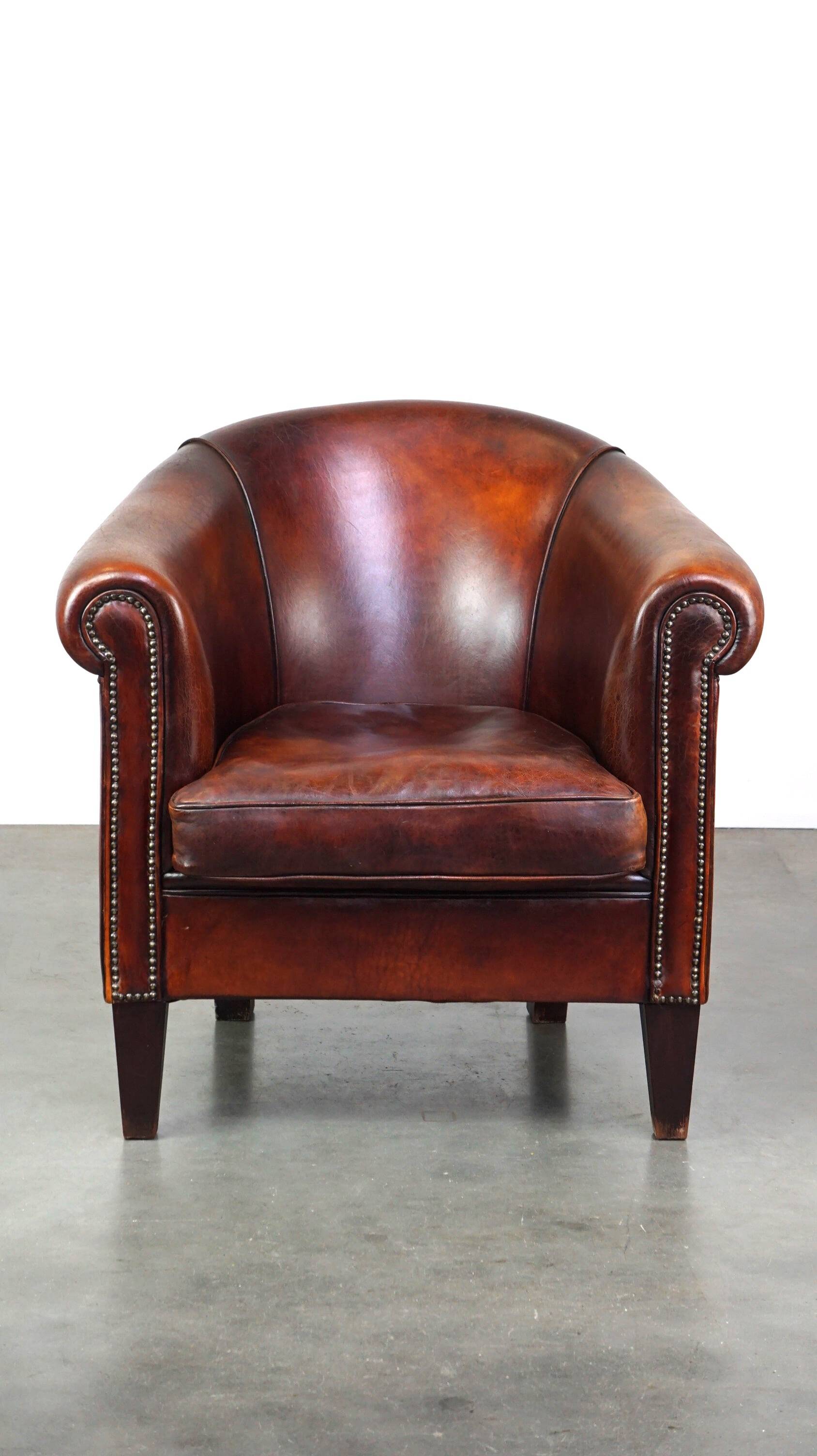 Very luxurious dark brown sheepskin club chair with a more than beautiful patina