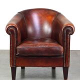 Very luxurious dark brown sheepskin club chair with a more than beautiful patina