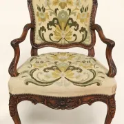 Louis XV cabriolet armchair, carved walnut, petit point tapestry, 18th century.