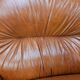 2 fauteuils en cuir cognac, années 1970