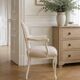 Louis XV style armchair in patinated beige, upholstered in beige fabric.