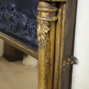 Large antique gilded wooden mirror with terracotta relief from the Empire period.