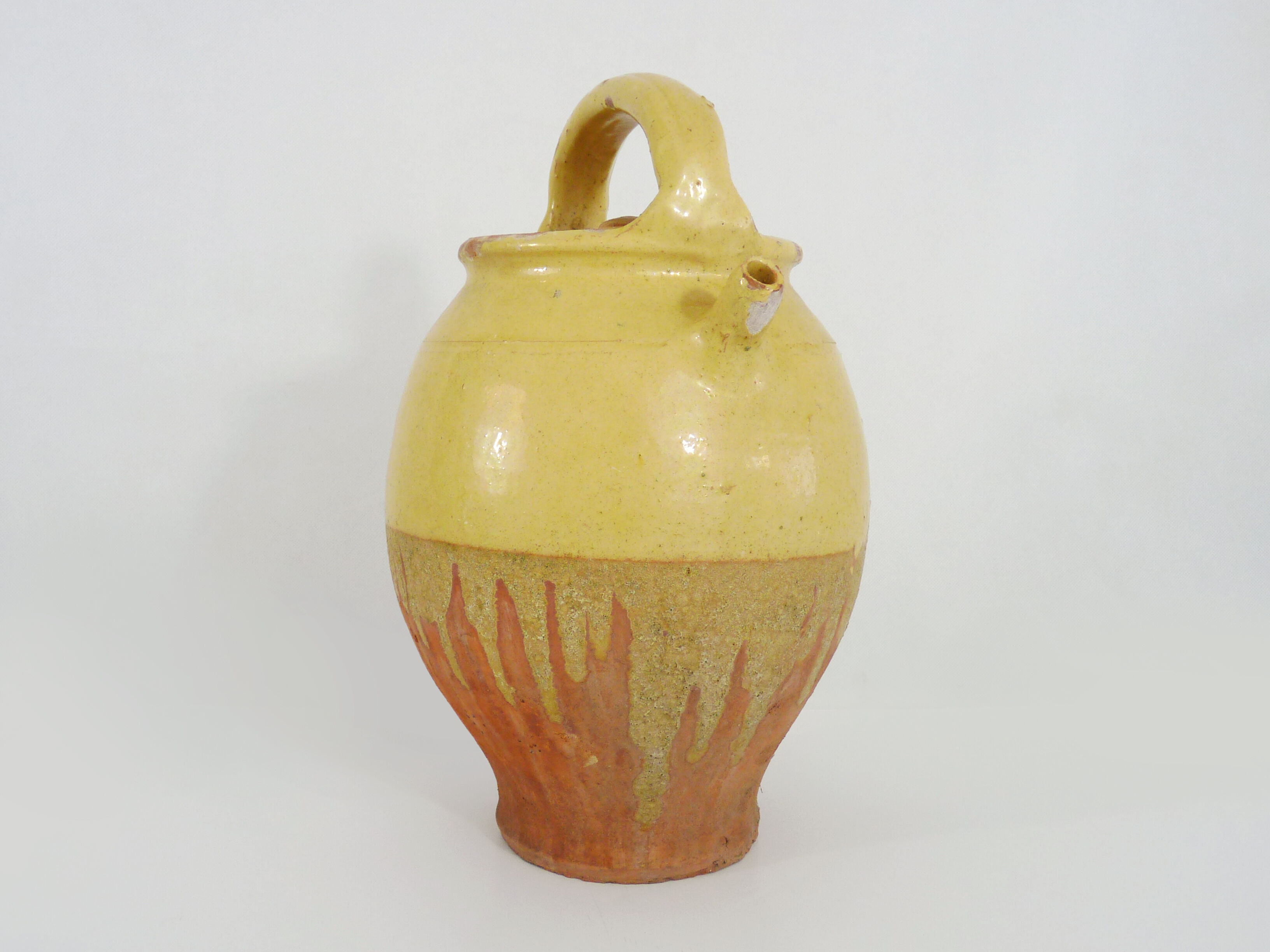 Old jug, chevrette, water pitcher in glazed yellow sandstone. Early twentieth century