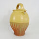 Old jug, chevrette, water pitcher in glazed yellow sandstone. Early twentieth century