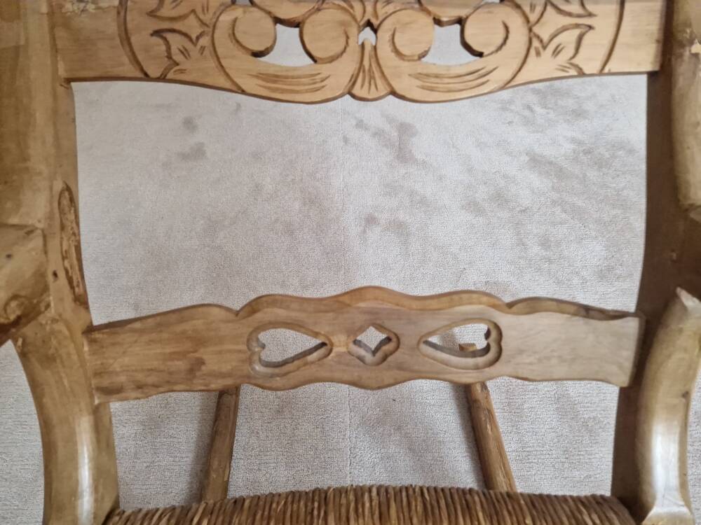 Oak rocking chair with a straw seat.