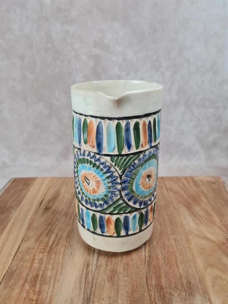 Old pitcher in Tunisian earthenware with colourful decoration.