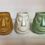 Set of three small Moai-style head vases.