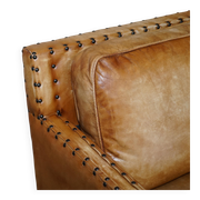 Three-seater leather canapé in Edwardian style with studs.