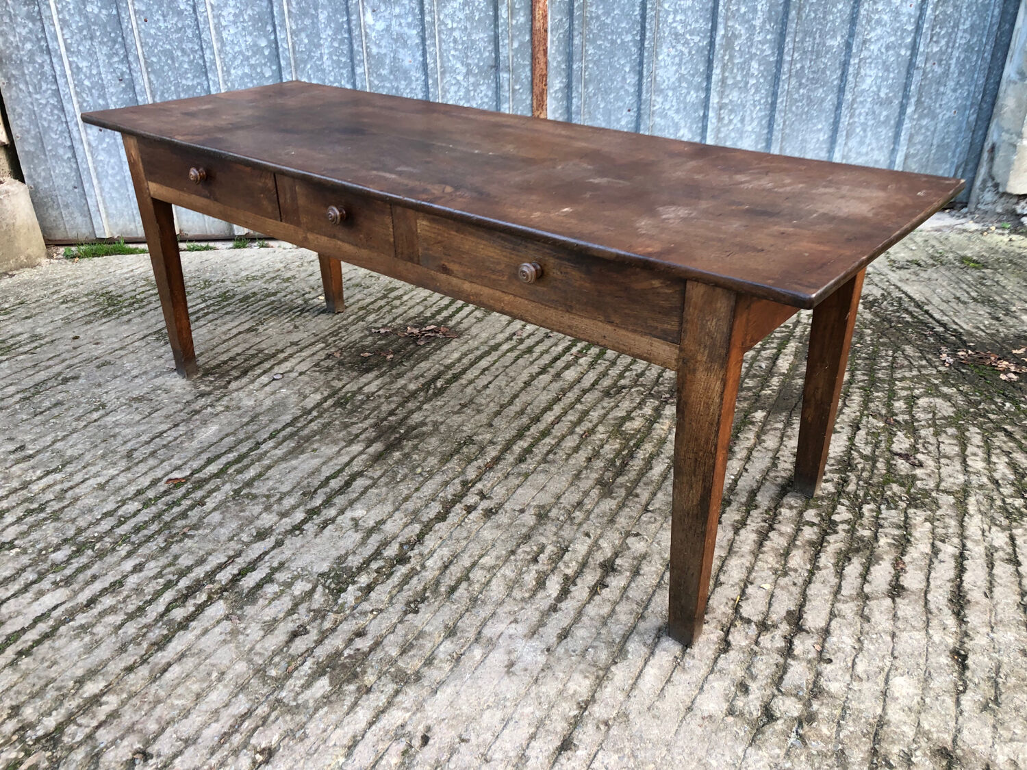 Antique chestnut farmhouse table with 3 drawers on the front.