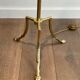 Brass floor lamp with a tripod base and claw feet from Maison Jansen.