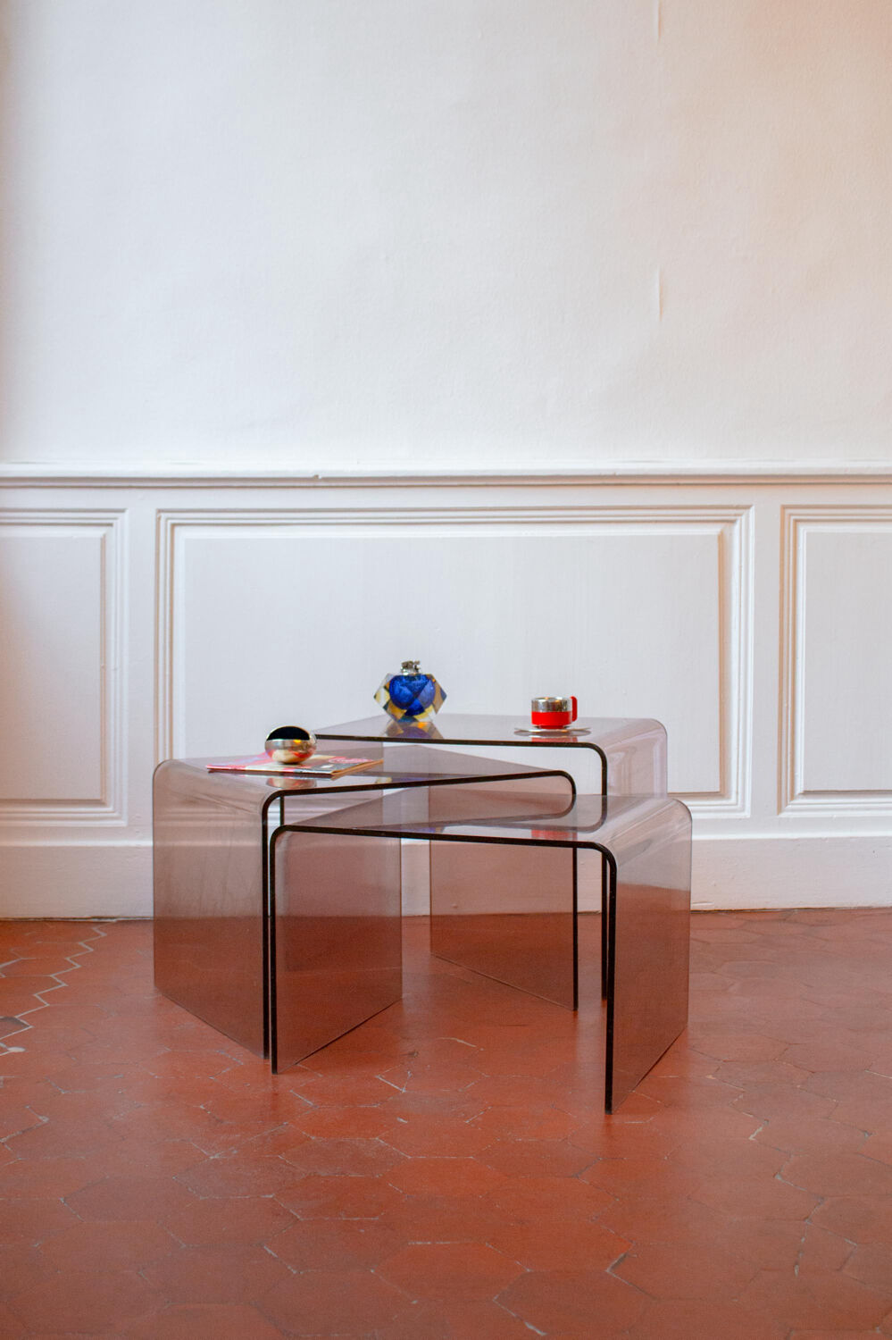 Vintage trio of nesting tables in smoked plexiglass by Michel Dumas, year.