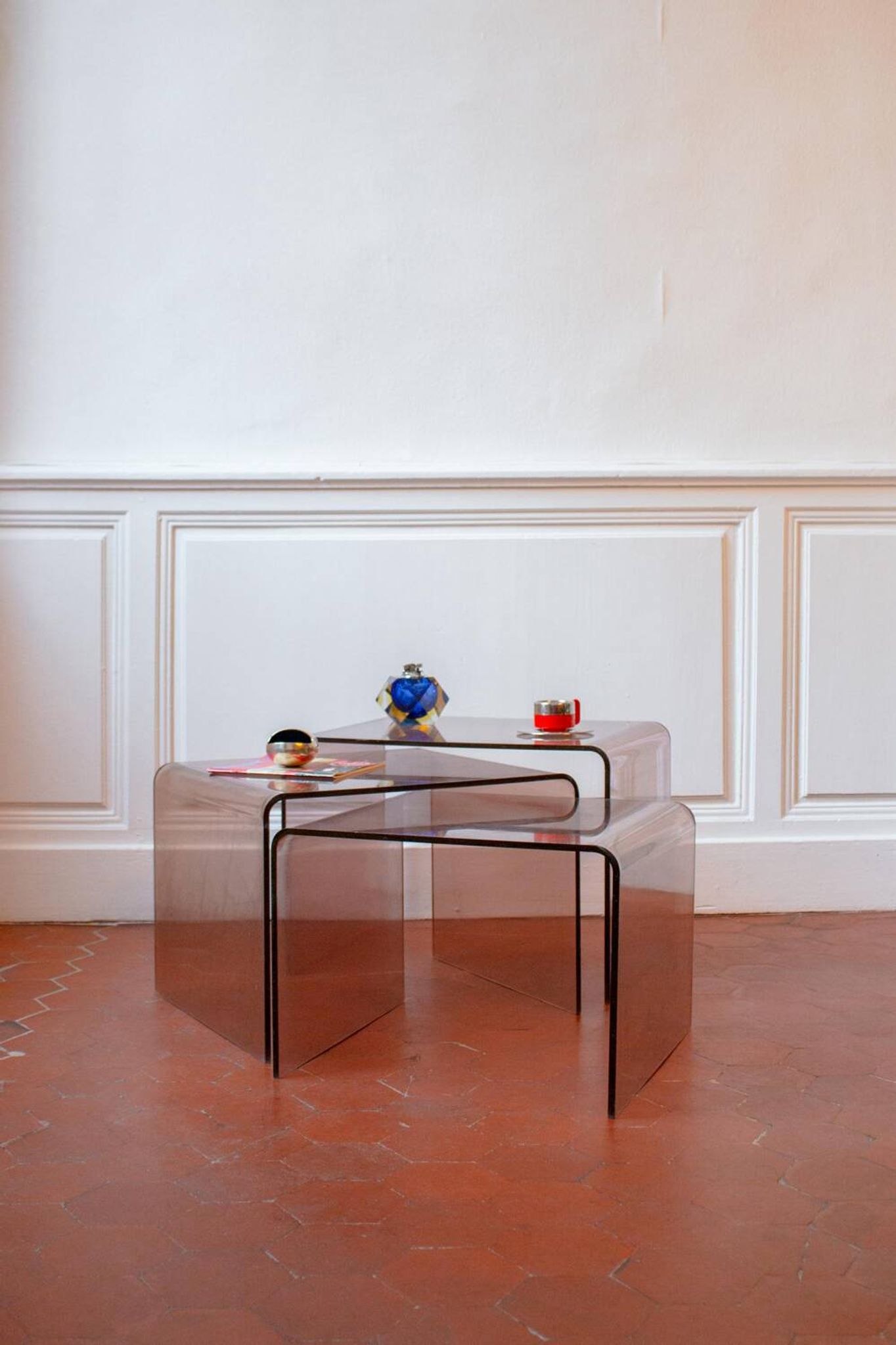 Vintage trio of nesting tables in smoked plexiglass by Michel Dumas, year.