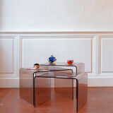 Vintage trio of nesting tables in smoked plexiglass by Michel Dumas, year.
