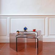 Vintage trio of nesting tables in smoked plexiglass by Michel Dumas, year.