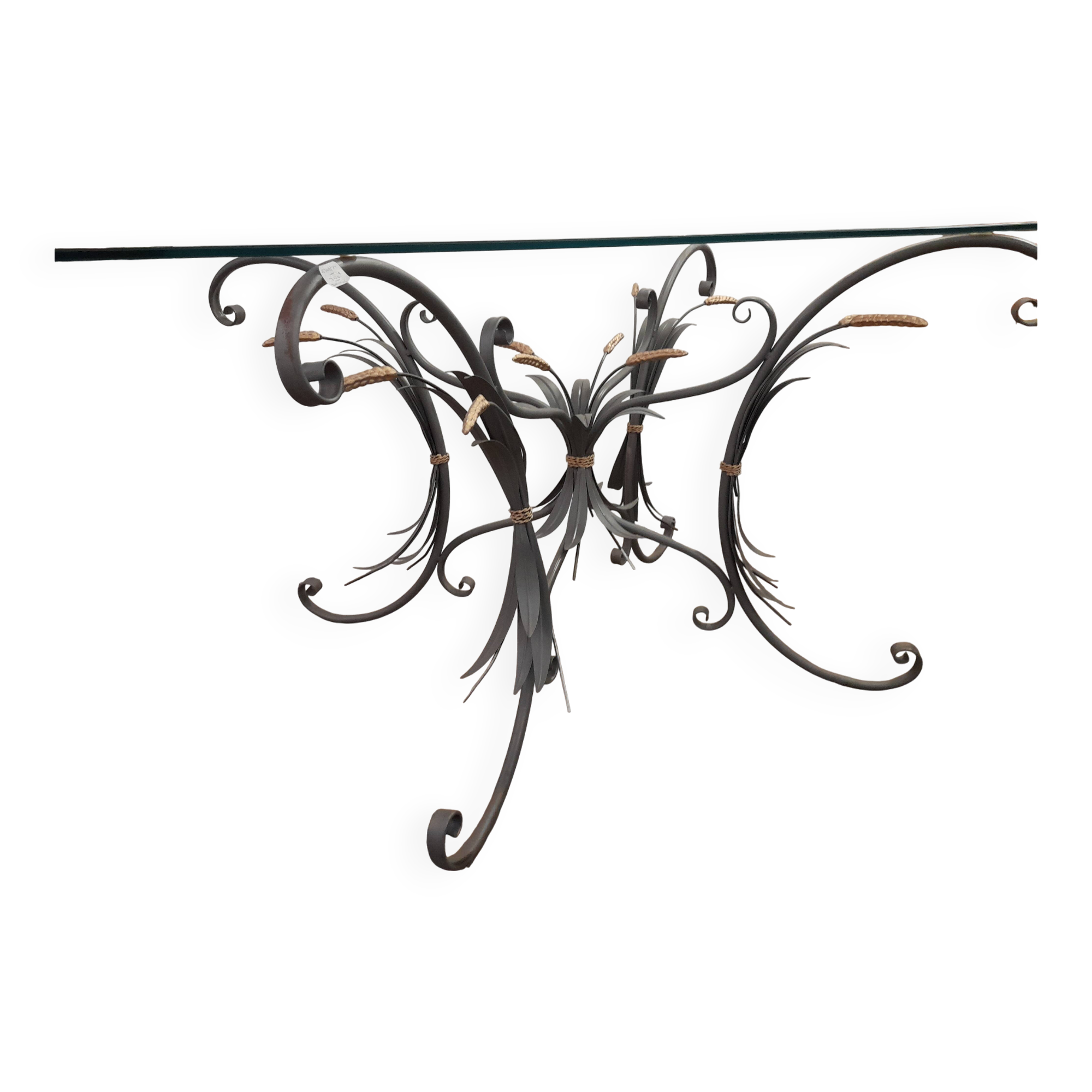 Glass top table with iron base in the style of wheat ears. Attributed to Robert Goossens.