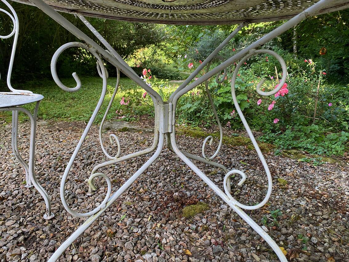 Part of a white lacquered wrought iron garden furniture set