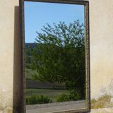 Mirror with black and gold frame, embossed vine leaves