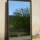 Mirror with black and gold frame, embossed vine leaves