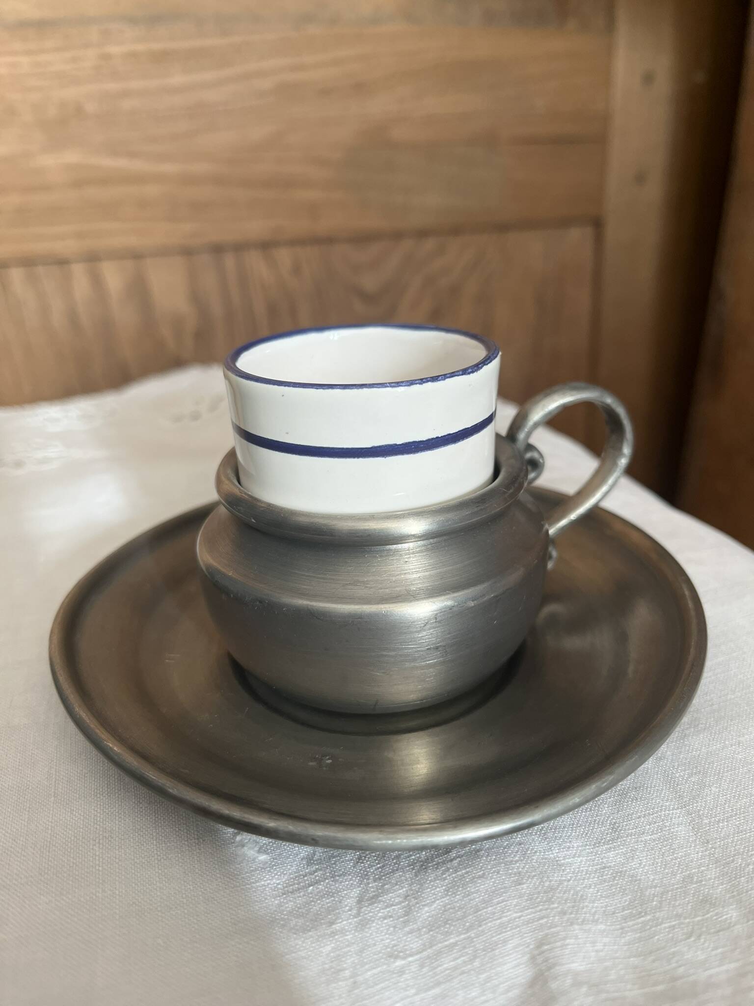 Pewter and porcelain cup and saucer