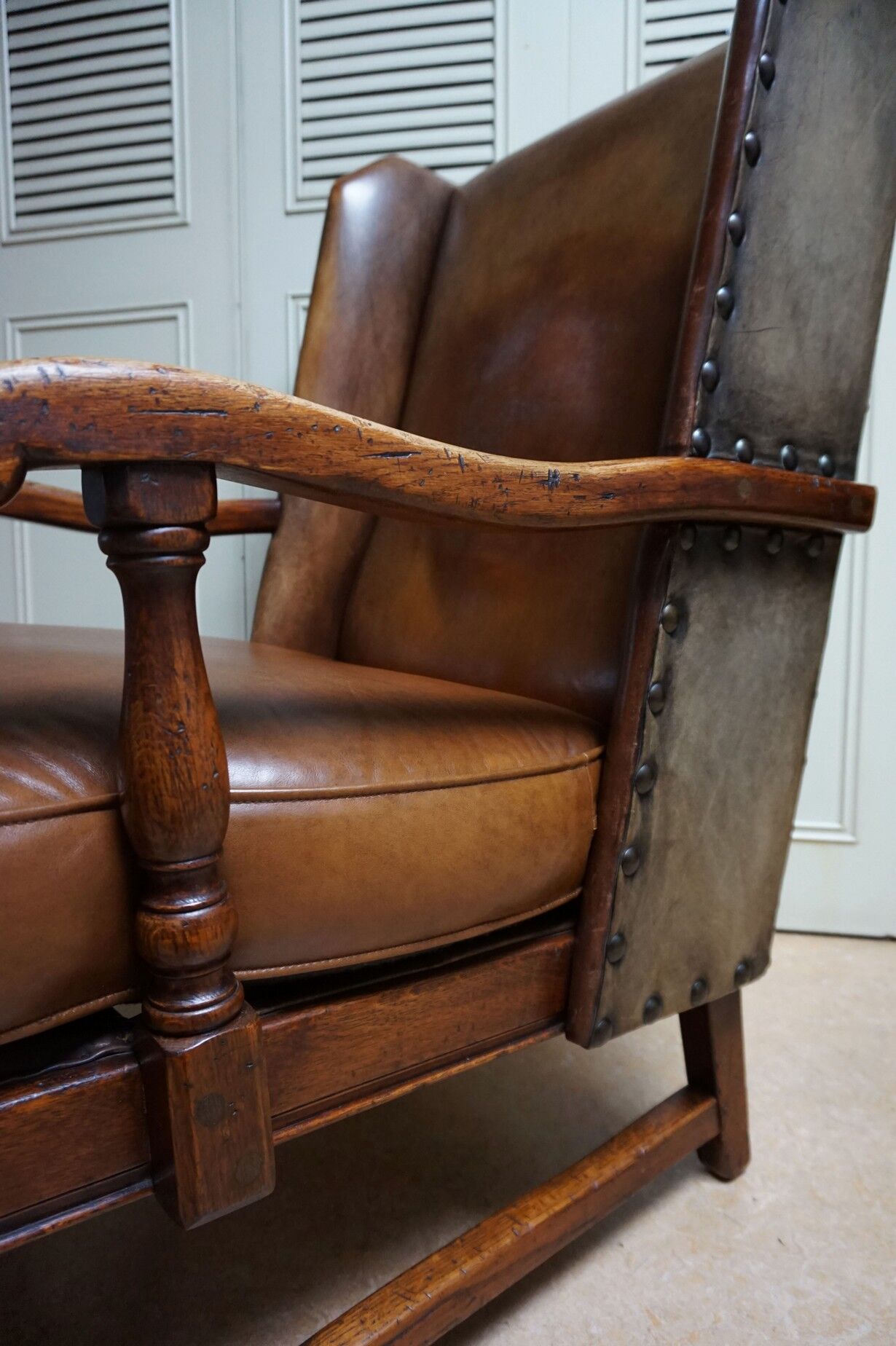 English high back cognac leather wingchair by Criterion cord