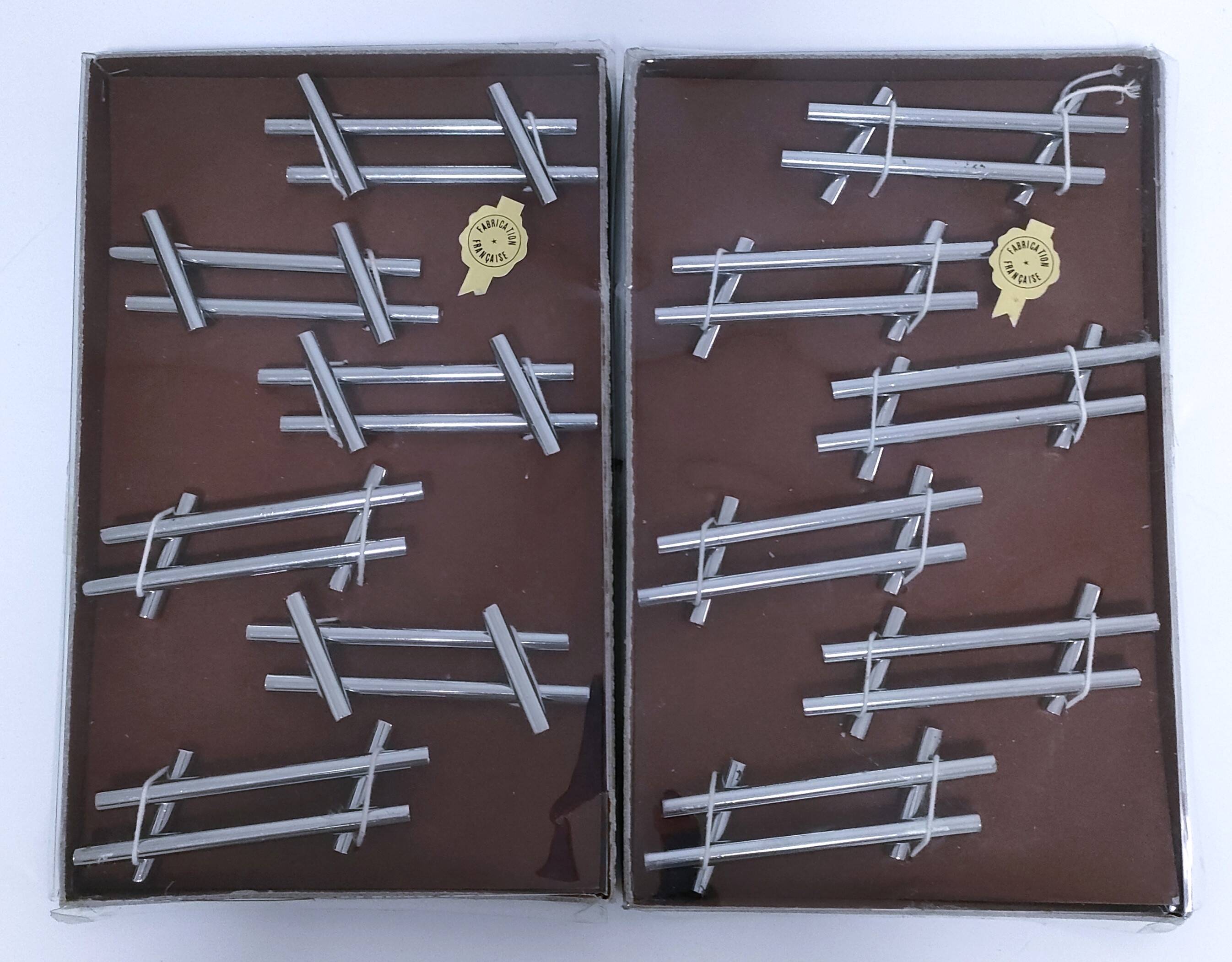 Twelve 70s design metal knife holders